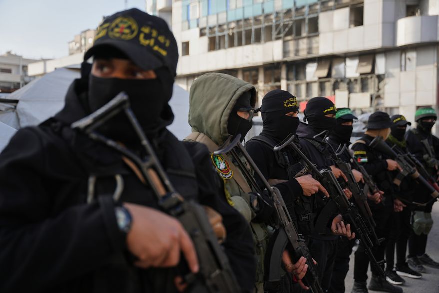 FILE - Armed Palestinian militants from Hamas and Islamic Jihad gather next to Eid al-Fitr prayers in Gaza City, March 20, 2026. (AP Photo/Abdel Kareem Hana, File)