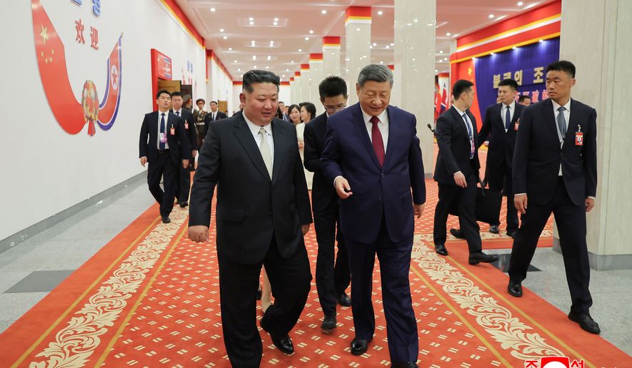 In this photo provided by the North Korean government, North Korean leader Kim Jong-un, left, and Chinese President Xi Jinping, right, walk together after a welcome performance in Pyongyang, Monday, June 8, 2026. Independent journalists were not given access to cover the event depicted in this image distributed by the North Korean government. The content of this image is as provided and cannot be independently verified. Korean language watermark on image as provided by source reads: "KCNA" which is the abbreviation for Korean Central News Agency. (Korean Central News Agency/Korea News Service via AP)
