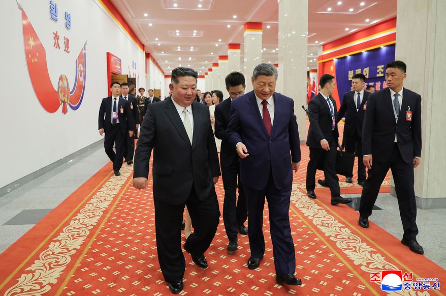 In this photo provided by the North Korean government, North Korean leader Kim Jong-un, left, and Chinese President Xi Jinping, right, walk together after a welcome performance in Pyongyang, Monday, June 8, 2026. Independent journalists were not given access to cover the event depicted in this image distributed by the North Korean government. The content of this image is as provided and cannot be independently verified. Korean language watermark on image as provided by source reads: "KCNA" which is the abbreviation for Korean Central News Agency. (Korean Central News Agency/Korea News Service via AP)