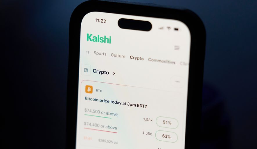 A phone displays crypto prices on the Kalshi app on April 16, 2026, in Portland, Ore. (AP Photo/Jenny Kane, File)