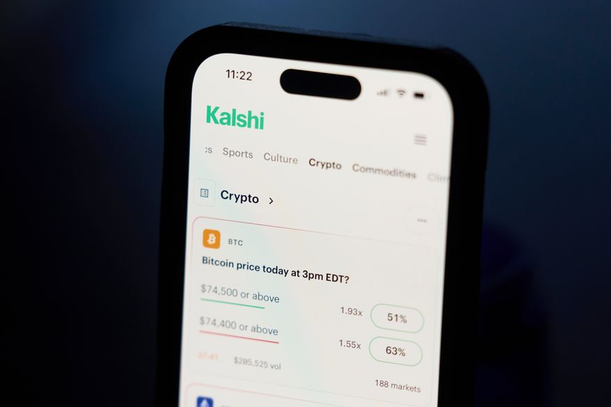 A phone displays crypto prices on the Kalshi app on April 16, 2026, in Portland, Ore. (AP Photo/Jenny Kane, File)