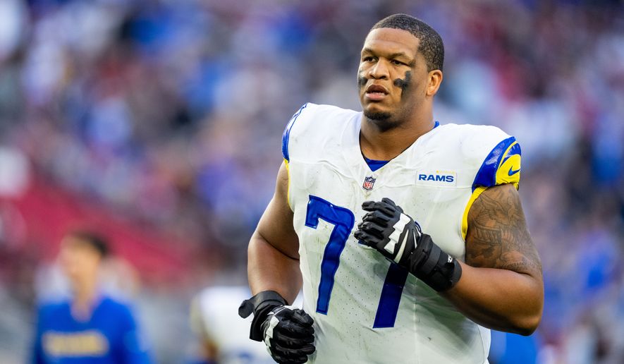 FILE - Los Angeles Rams offensive tackle Alaric Jackson (77) runs off the field at halftime during an NFL football game against the Arizona Cardinals, Dec. 7, 2025, in Glendale, Ariz. (AP Photo/Samantha Chow, File)