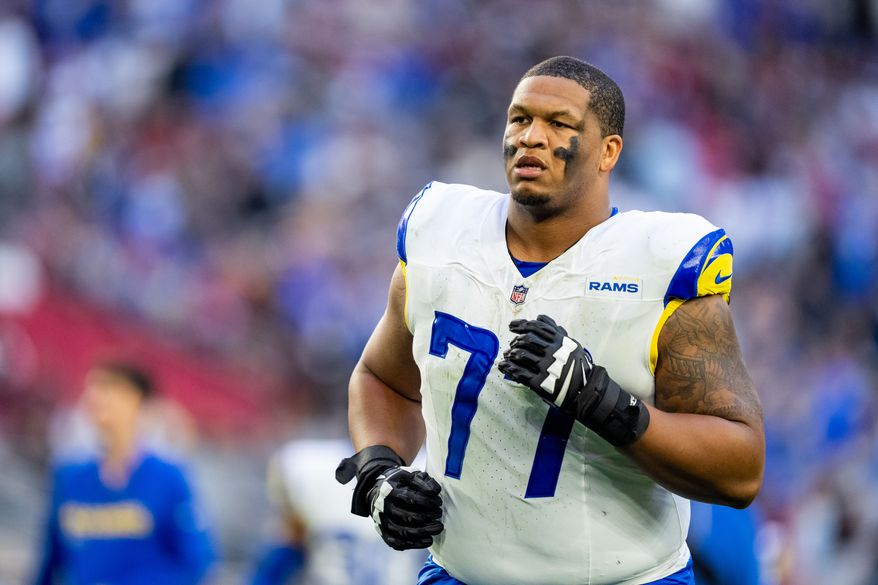 FILE - Los Angeles Rams offensive tackle Alaric Jackson (77) runs off the field at halftime during an NFL football game against the Arizona Cardinals, Dec. 7, 2025, in Glendale, Ariz. (AP Photo/Samantha Chow, File)