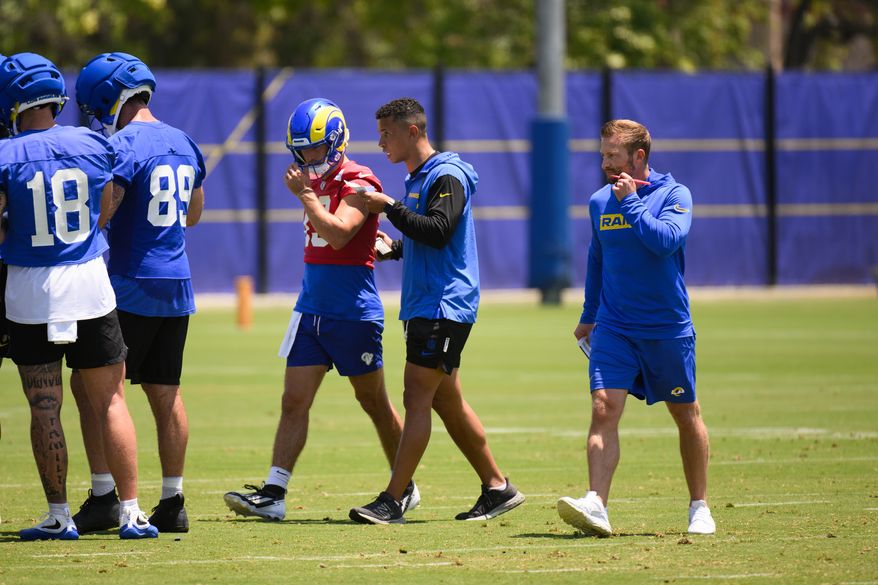 Los Angeles Rams offensive coordinator Nate Scheelhaase, center, gives instructions to quarterback Stetson Bennett IV (13) during the NFL football team's practice, Tuesday, June 2, 2026, in Woodland Hills, Calif. (AP Photo/Kyusung Gong)