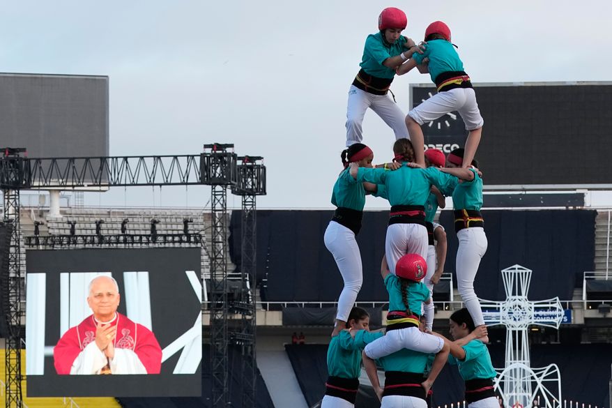 Performers make a human tower, known as Castells, for Pope Leo XIV as he leads a vigil of prayer at the Lluis Companys Olympic Stadium, in Barcelona, Tuesday, June 9, 2026. (AP Photo/Alessandra Tarantino)