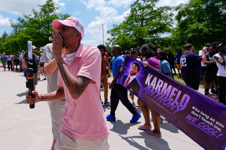 A person walks around announcing the guilty verdict in the Karmelo Anthony trial in front of the Collin County courthouse, Tuesday, June 9, 2026, in McKinney, Texas. (AP Photo/Tony Gutierrez)