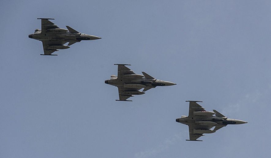 Three of the five Saab JAS-39 Gripen aircraft of the Hungarian Air Force returning from the 55th NATO Tiger Meet Aviation Exercise fly above the 59th Air Base of the Hungarian Army in Kecskemet, 85 kms southeast of Budapest, Hungary, Friday, May 27, 2016. NATO's aviation exercise this year was hosted by Spain in Zaragoza, where nearly a thousand soldiers representing fifteen nations took part in the event running from 16 to 27 May, including a fifty-strong Hungarian contingent. (Sandor Ujvari/MTI via AP) **FILE**