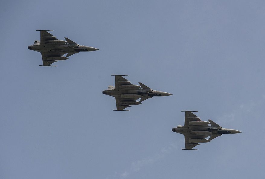 Three of the five Saab JAS-39 Gripen aircraft of the Hungarian Air Force returning from the 55th NATO Tiger Meet Aviation Exercise fly above the 59th Air Base of the Hungarian Army in Kecskemet, 85 kms southeast of Budapest, Hungary, Friday, May 27, 2016. NATO's aviation exercise this year was hosted by Spain in Zaragoza, where nearly a thousand soldiers representing fifteen nations took part in the event running from 16 to 27 May, including a fifty-strong Hungarian contingent. (Sandor Ujvari/MTI via AP) **FILE**