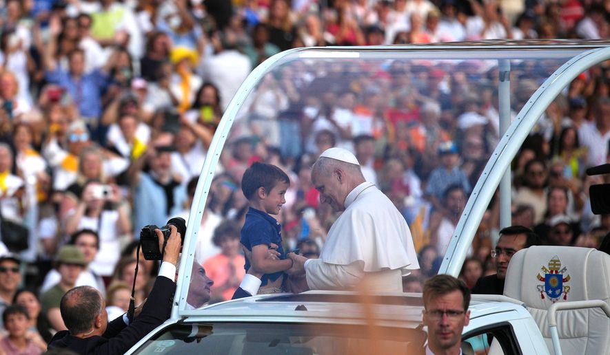 Pope Leo XIV blesses a child before a prayer vigil at Lluis Companys Olympic Stadium in Barcelona, Spain, Tuesday, June 9, 2026. (AP Photo/Emilio Morenatti)