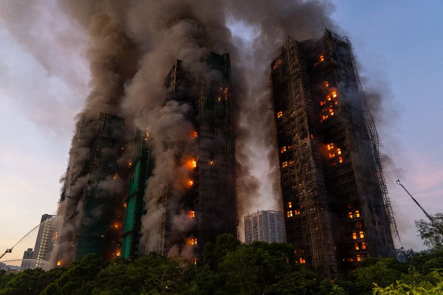 Smoke rises after a fire broke out at Wang Fuk Court, a residential estate in the Tai Po district of Hong Kong's New Territories, Nov. 26 2025. (AP Photo/Chan Long Hei, File)