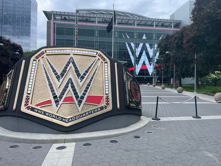 A large replica of the pro wrestling championship belt stands outside in a plaza in front of the world headquarters of WWE in Stamford, Connecticut. File photo credit: James Kirkikis via Shutterstock.