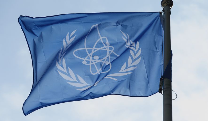 FILE - The flag of the International Atomic Energy Agency (IAEA) flies during a special session of an IAEA Board of Governors meeting in Vienna, Austria, March 2, 2026. (AP Photo/Heinz-Peter Bader, File)