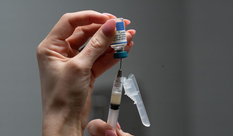 FILE - Lauren Ellenburg, a nurse, prepares a combination measles, mumps and rubella vaccine for a patient at Tiger Pediatrics in Easley, S.C., March 17, 2026. (AP Photo/Mary Conlon, File)