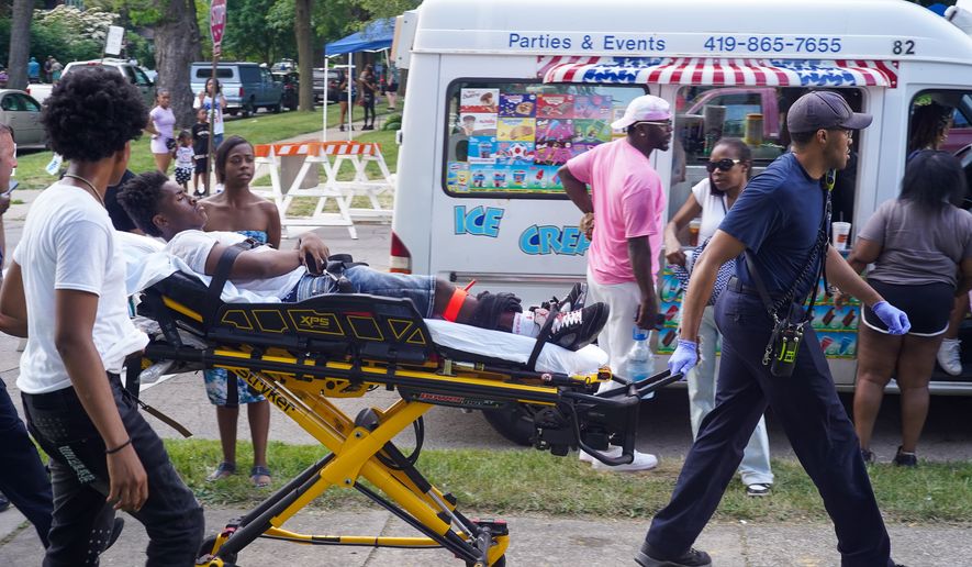 Paramedics treat a person after multiple people were shot at a community festival Saturday, June 6, 2026, in Toledo, Ohio. (Rich Berry via AP)