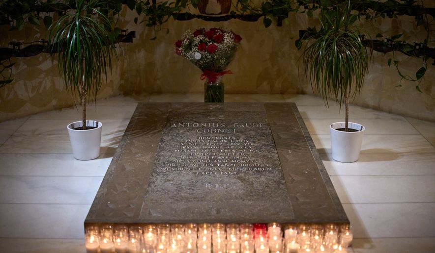Antoni Gaudí's tomb is photographed inside crypt of Gaudí beneath the Sagrada Família as crowds of visitors fill the basilica above in Barcelona, Spain, May 15, 2026. (AP Photo/Emilio Morenatti)