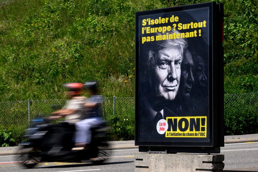 A poster reading "Isolate ourselves from Europe? Certainly not now! - No to the SVP/UDC Chaos initiative" featuring images of President Donald Trump, Russian President Vladimir Putin and Chinese President Xi Jinping, urging people to vote against the Swiss People's Party (SVP) referendum titled "No to a Switzerland with 10 million inhabitants" photographed in Lausanne, May 27, 2026. (Laurent Gillieron/Keystone via AP)