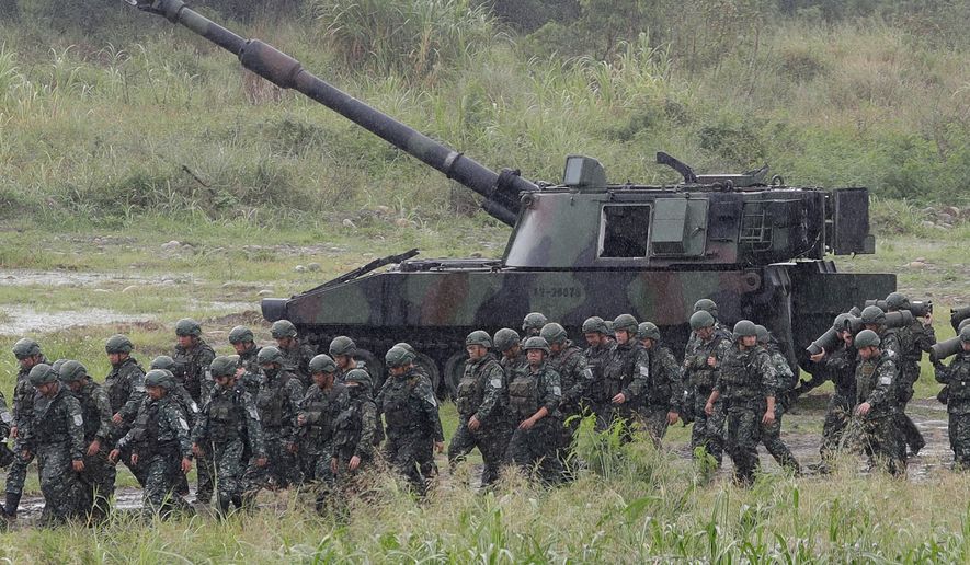 Soldiers move past a self-propelled howitzer during a military live-fire shooting training in Taichung City, Taiwan, Tuesday, June 9, 2026. (AP Photo/Chiang Ying-ying)