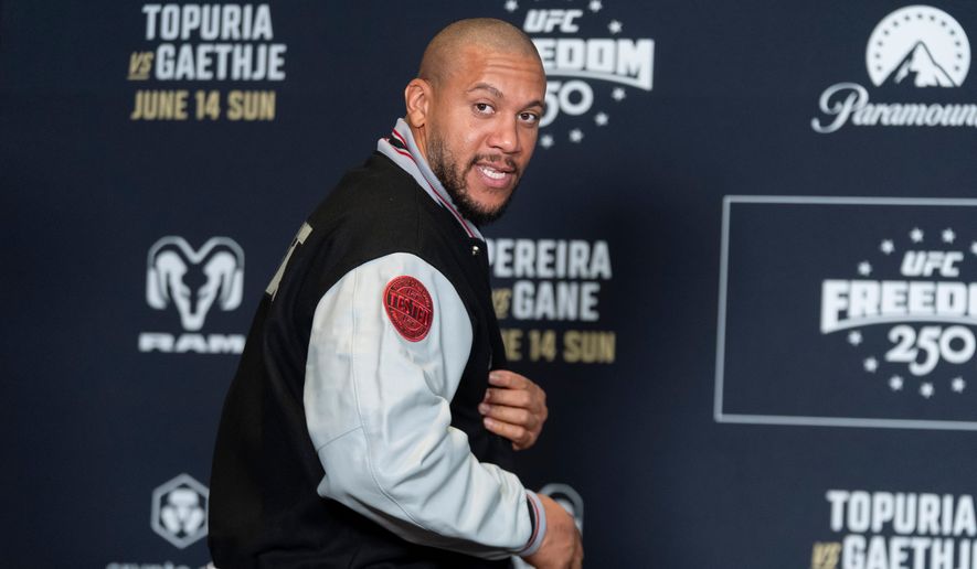 UFC heavyweight fighter Cyril Gane of Franceshows a patch on the sleeve of his jacket during the UFC Freedom 250 media day, Wednesday, June 10, 2026, in Washington. (AP Photo/Manuel Balce Ceneta)