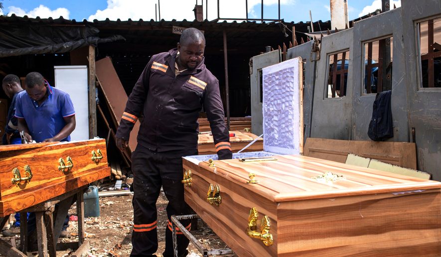 Manenji Chikwekwete, a low-cost coffin maker, at his workplace in Harare, Zimbabwe, March 13, 2026.(AP Photo/Aaron Ufumeli)