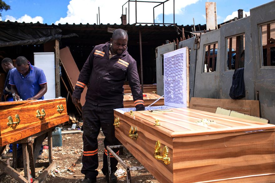 Manenji Chikwekwete, a low-cost coffin maker, at his workplace in Harare, Zimbabwe, March 13, 2026.(AP Photo/Aaron Ufumeli)