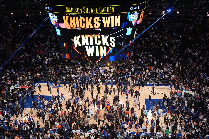 Players and fans celebrate after the New York Knicks' victory over the San Antonio Spurs in Game 4 of the NBA Finals basketball series, Wednesday, June 10, 2026, in New York. (AP Photo/Frank Franklin II)