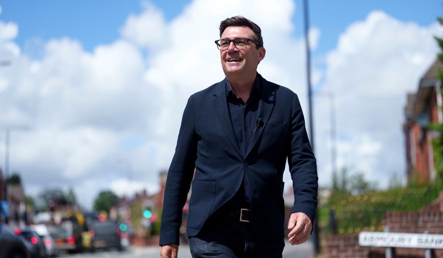 Andy Burnham smiles during a campaign visit to Ashton-in-Makerfield before the forthcoming by-election, in Manchester, England, Tuesday, June 9, 2026. CORRECTION: corrects family name to Burnham instead of Bunham (AP Photo/Jon Super)
