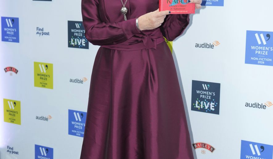 Lyse Doucet holding her book The Finest Hotel in Kabul: A People's History of Afghanistan, poses for a photograph at the 2026 Women's Prize Trust Summer Party & Awards Ceremony in London, Thursday, June 11, 2026. (AP Photo/Kin Cheung)