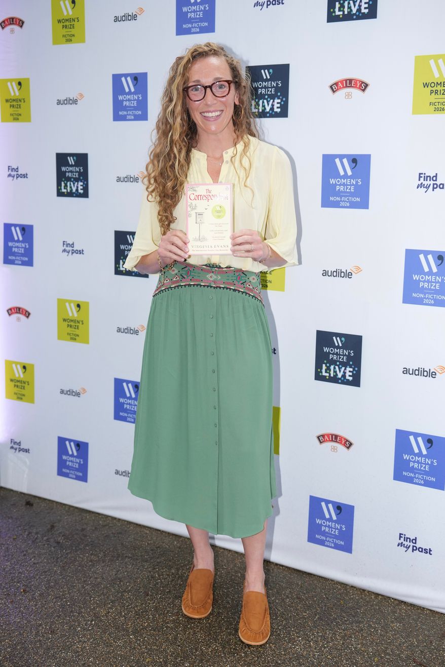 Virginia Evans holding her book The Correspondent, poses for a photograph at the 2026 Women's Prize Trust Summer Party & Awards Ceremony in London, Thursday, June 11, 2026. (AP Photo/Kin Cheung)