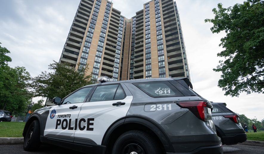 Investigators work the scene where a Toronto Police officer was shot in Toronto on Thursday, June 11, 2026. (Arlyn McAdorey/The Canadian Press via AP)