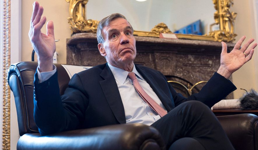 Sen. Mark Warner, D-Va., the vice chair of the Senate Intelligence Committee, speaks to reporters about FISA, the law that allows the U.S. to gather intelligence abroad, at the Capitol in Washington, Thursday, June 11, 2026. (AP Photo/J. Scott Applewhite)