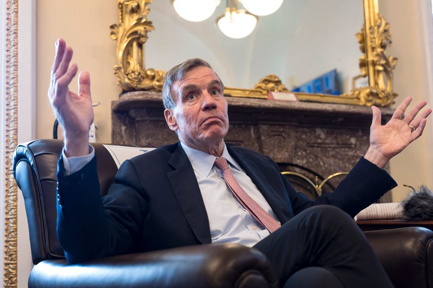 Sen. Mark Warner, D-Va., the vice chair of the Senate Intelligence Committee, speaks to reporters about FISA, the law that allows the U.S. to gather intelligence abroad, at the Capitol in Washington, Thursday, June 11, 2026. (AP Photo/J. Scott Applewhite)