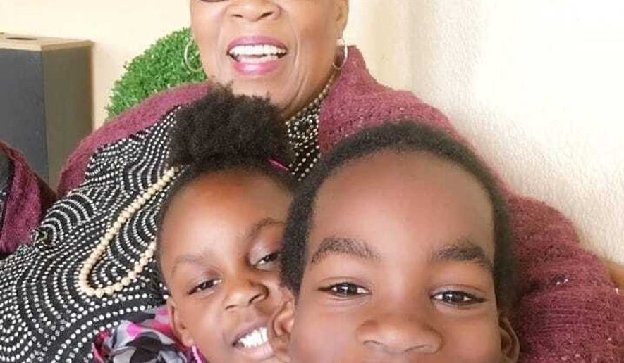 In this undated photo made available by Morenike Evans, former AP reporter Marlene Johnson poses with her granddaughter, Naija Evans, and grandson, Donovan Evans. (Morenike Evans via AP)