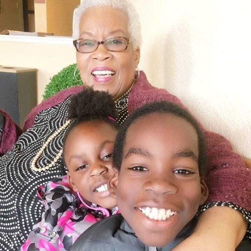 In this undated photo made available by Morenike Evans, former AP reporter Marlene Johnson poses with her granddaughter, Naija Evans, and grandson, Donovan Evans. (Morenike Evans via AP)