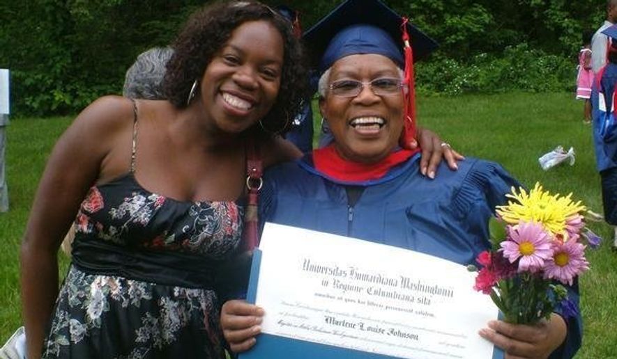 In this undated photo made available by Morenike Evans, Morenike Joela Evans (left) and her mother, Marlene Johnson, pose during Johnson's Howard University graduation with a master's degree in Religious Studies in Washington. (Morenike Evans via AP)