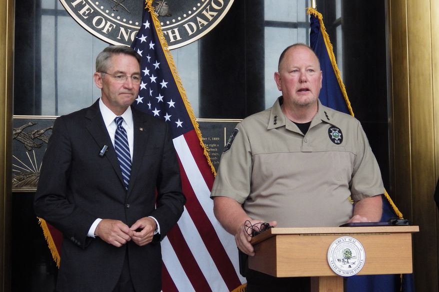North Dakota Republican Attorney General Drew Wrigley, left, listens as Morton County Sheriff Kyle Kirchmeier addresses reporters at the state Capitol in Bismarck, N.D., on Thursday, June 11, 2026. (AP Photo/Jack Dura)