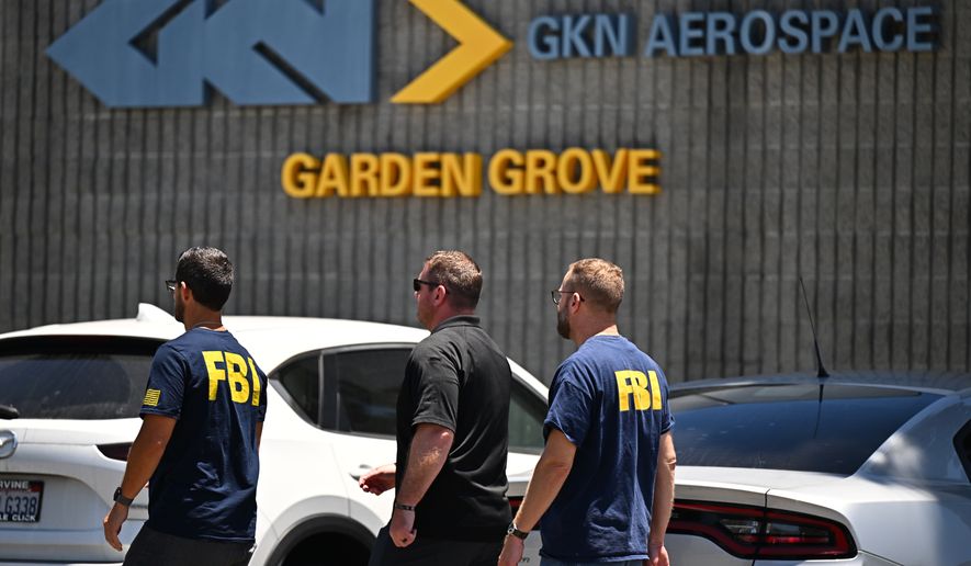 FBI agents work around GKN Aerospace in Garden Grove, Calif. on Wednesday, June 10, 2026. (AP Photo/William Liang)