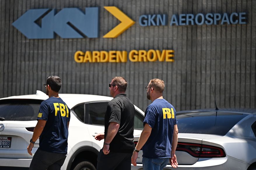 FBI agents work around GKN Aerospace in Garden Grove, Calif. on Wednesday, June 10, 2026. (AP Photo/William Liang)
