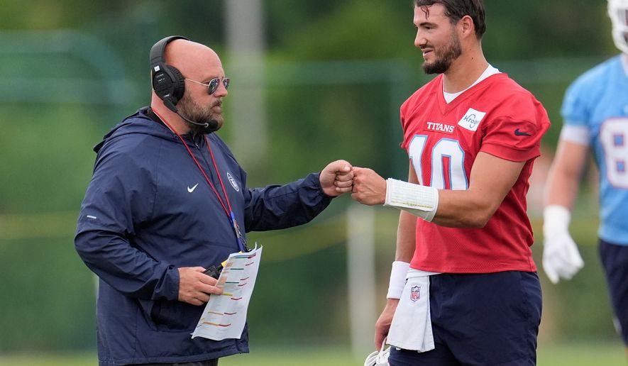 Tennessee Titans offensive coordinator Brian Daboll greets quarterback Mitch Trubisky (10) during an NFL football practice Monday, June 8, 2026, in Nashville, Tenn. (AP Photo/George Walker IV)