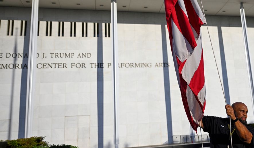 The American flag is raised in front of The John F. Kennedy Center for the Performing Arts, Friday, June 12, 2026, in Washington. (AP Photo/John McDonnell