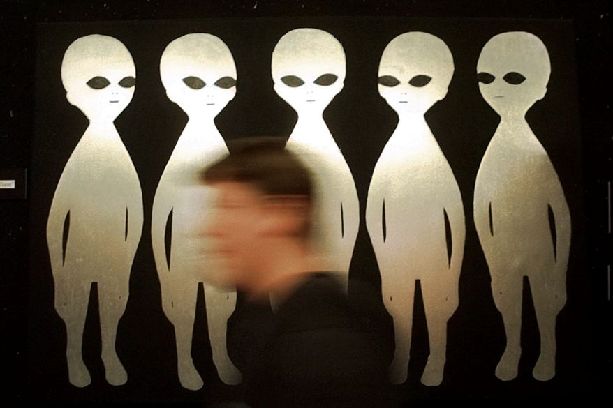 A patron passes a painting inside the International UFO Museum and Research Center in Roswell, N.M., on June 10, 1997. (AP Photo/Eric Draper) **FILE**