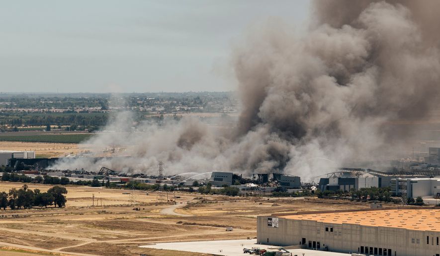 Smoke is seen from the massive fire at the Medline medical supply warehouse in Tracy, Calif., Friday, June 12, 2026. (Stephen Lam/San Francisco Chronicle via AP)