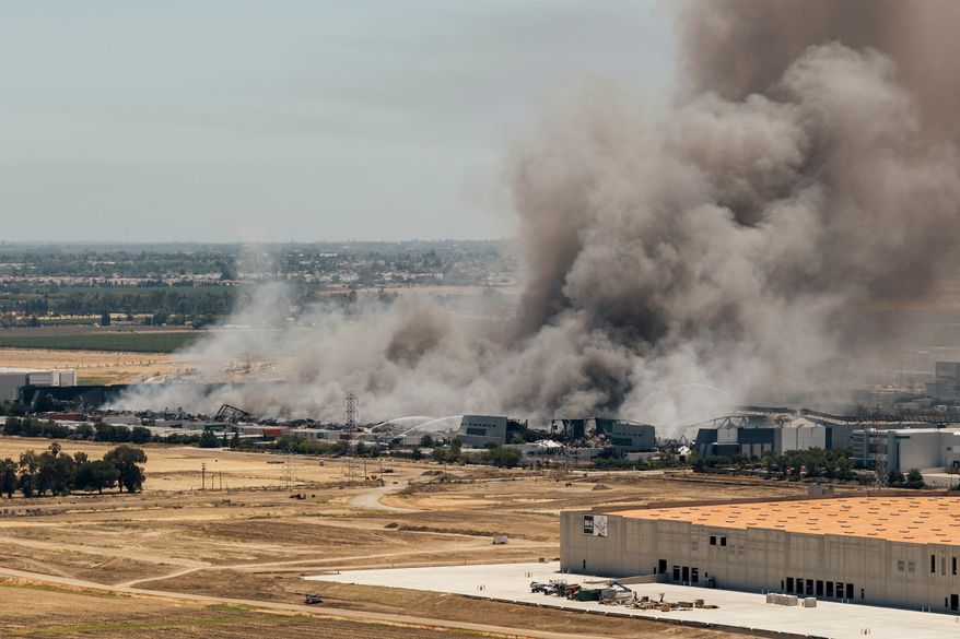 Smoke is seen from the massive fire at the Medline medical supply warehouse in Tracy, Calif., Friday, June 12, 2026. (Stephen Lam/San Francisco Chronicle via AP)