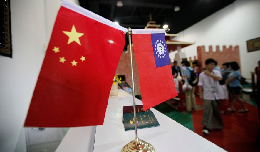 Flags of China and Myanmar are displayed at the entrance of Myanmar Pavilion prior to Myanmar's top junta leader Gen. Than Shwe to arrive at the Shanghai Expo site in Shanghai Friday, Sept.10, 2010. (AP Photo/Eugene Hoshiko, file)