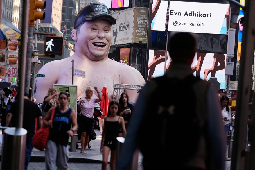 A large inflatable figure depicting Elon Musk stands in Times Square in New York on Thursday, June 11, 2026. (AP Photo/Seth Wenig)
