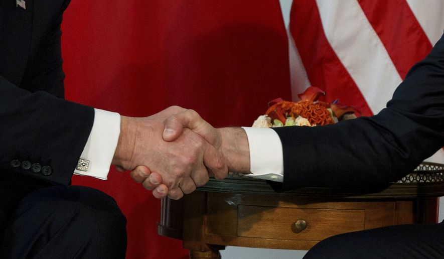 FILE - President Donald Trump shakes hands with French President Emmanuel Macron during a meeting at the U.S. Embassy, May 25, 2017, in Brussels. (AP Photo/Evan Vucci, file)
