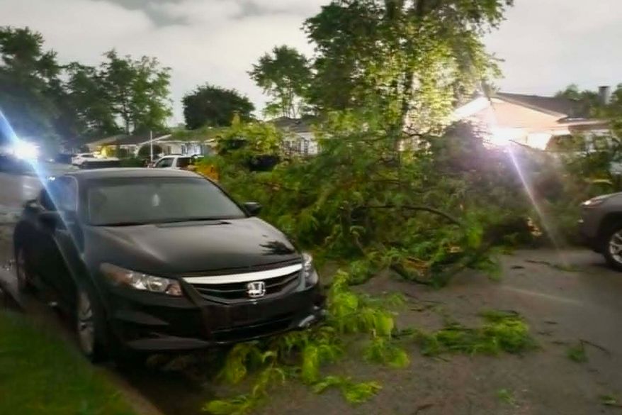 Damaged tree branches lie on a street in Elkhart, Ind., Thursday, June 11, 2026, following a severe weather system in the area. (Jennifer Hall via AP)