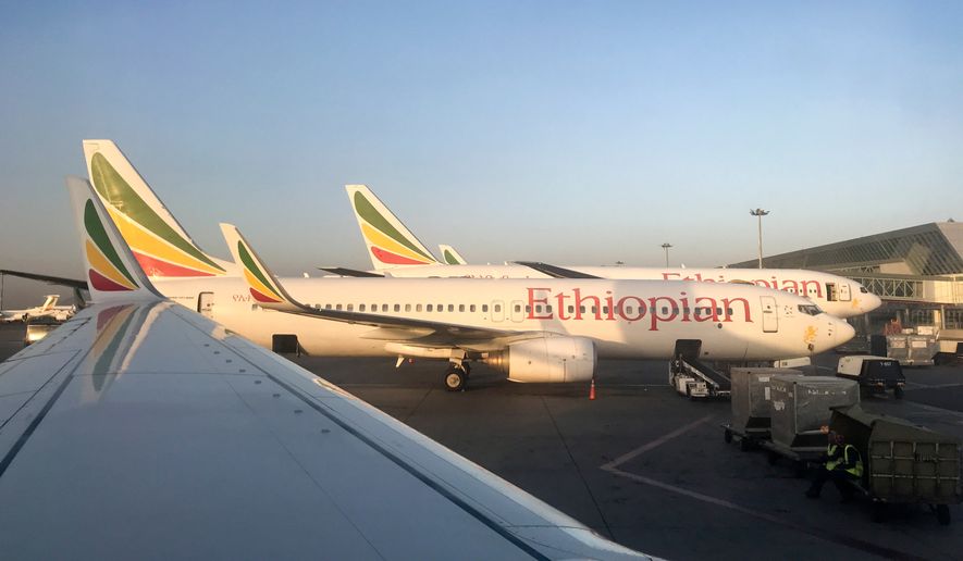 FILE - Ethiopian Airlines planes are parked at Bole International Airport in Addis Ababa, Ethiopia, Monday, Feb. 11, 2019. (AP Photo/Ben Curtis, File)