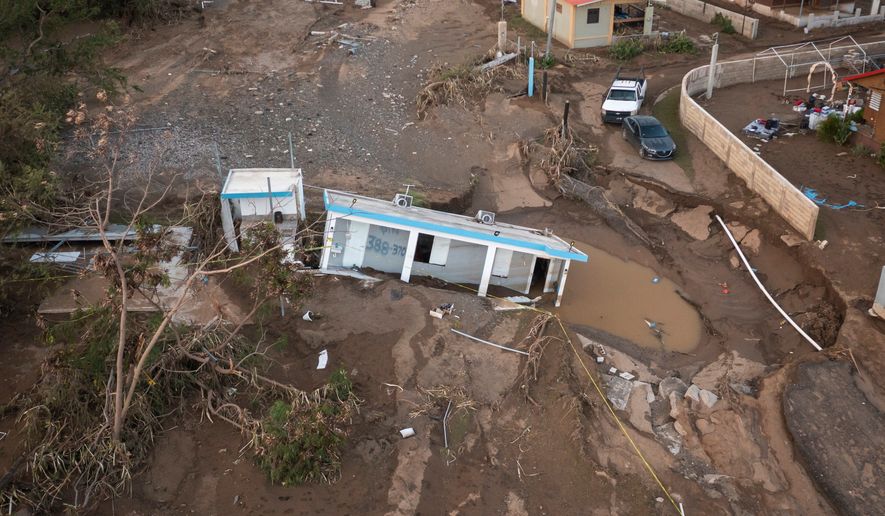 A house lays in the mud after it was washed away by Hurricane Fiona at Villa Esperanza in Salinas, Puerto Rico, Sept. 21, 2022. (AP Photo/Alejandro Granadillo)