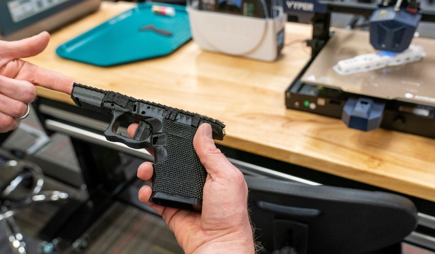 A handgun frame that has been printed on a 3D printer is held for a photograph at the Bureau of Alcohol, Tobacco, Firearms, and Explosives (ATF), National Services Center, March 2, 2023, in Martinsburg, W.Va. (AP Photo/Alex Brandon, File)