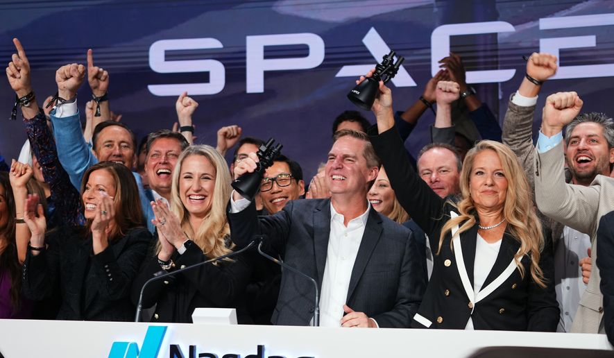 Gwynne Shotwell, President and COO of SpaceX, right, celebrates with colleagues during a bell ringing ceremony for the IPO of SpaceX at the Nasdaq MarketSite in New York, Friday, June 12, 2026, in New York. (AP Photo/Frank Franklin II)